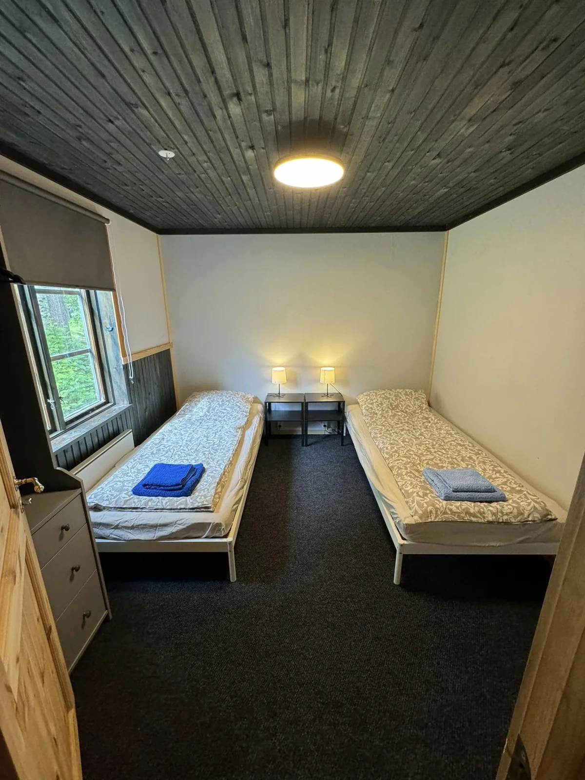 Two single beds in the downstairs bedroom of the large cabin