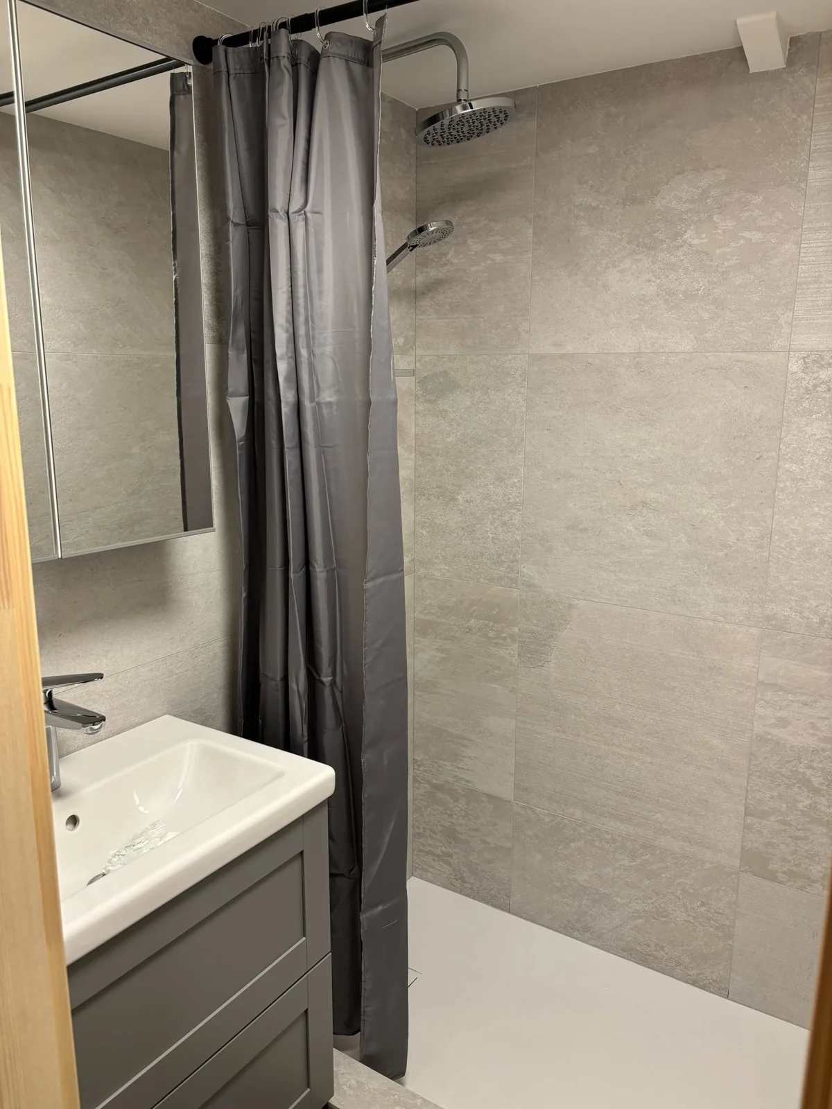 Rainfall shower and washbasin in the small cabin bathroom, with no toilet