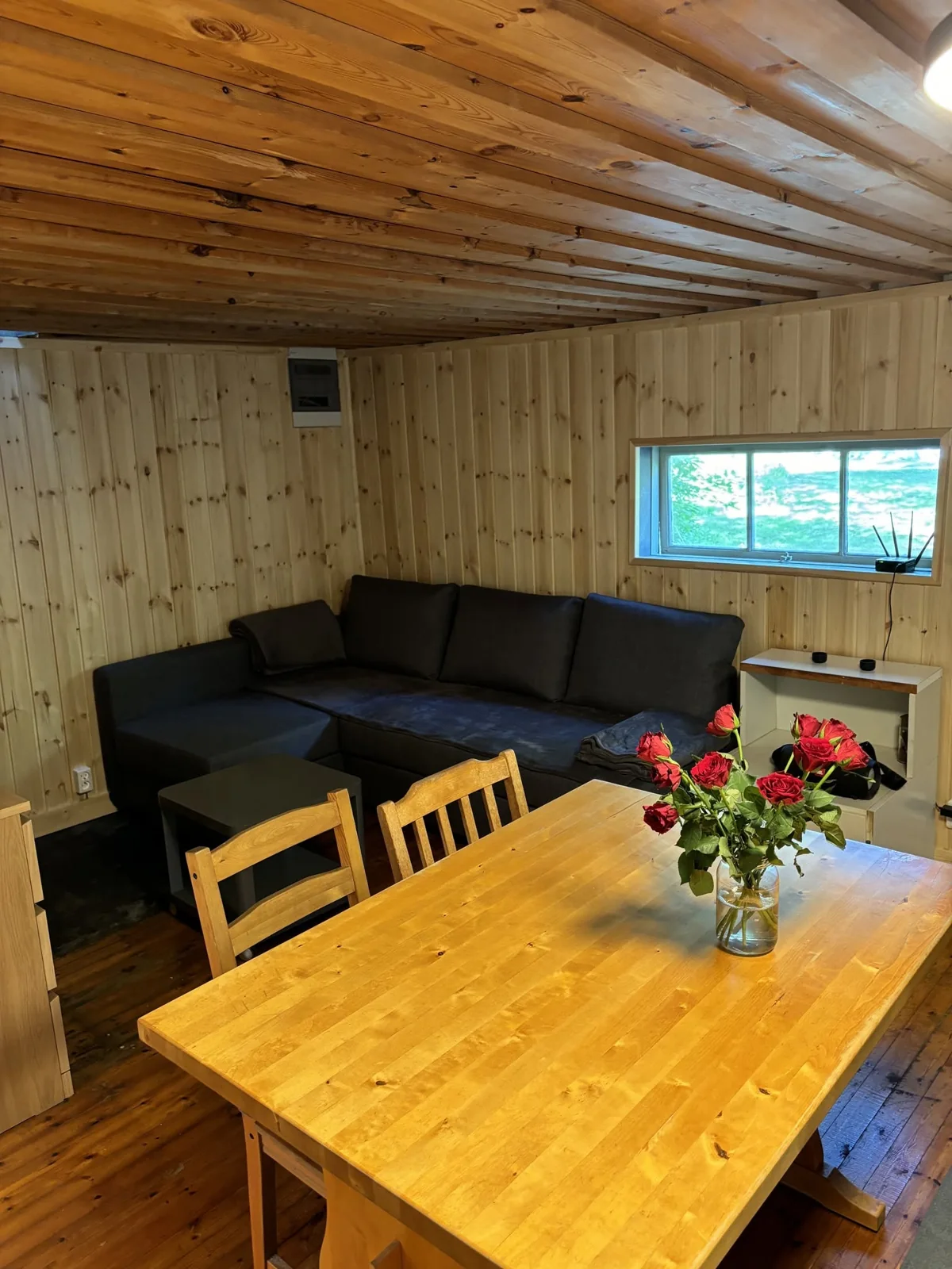 Corner sofa bed and dining table in the small cabin